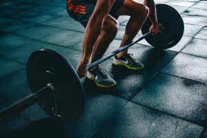 person-holding-barbell-841130